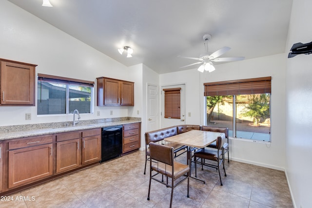 kitchen featuring light stone counters, black dishwasher, sink, lofted ceiling, and ceiling fan