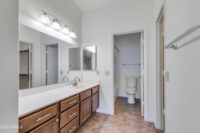 bathroom featuring toilet, vanity, and tile patterned floors