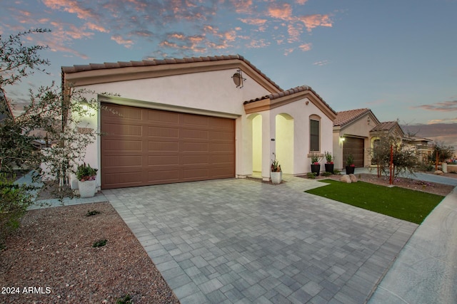 mediterranean / spanish-style home with a garage