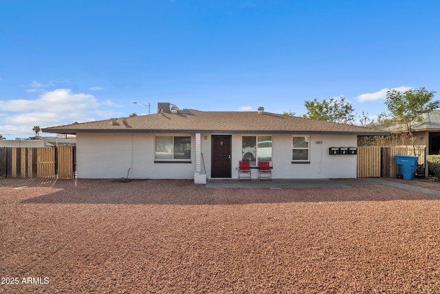 single story home featuring a patio and fence