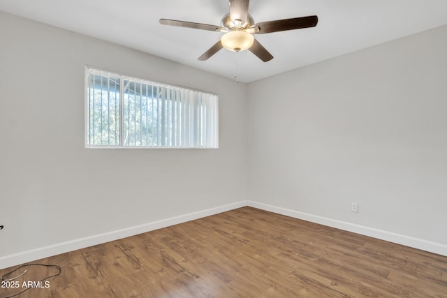 unfurnished room with ceiling fan, baseboards, and wood finished floors