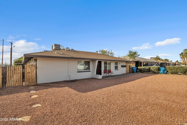 rear view of property with a patio, cooling unit, and fence