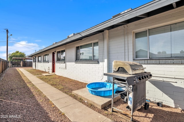 exterior space featuring fence and area for grilling