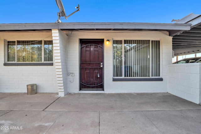 entrance to property featuring concrete block siding