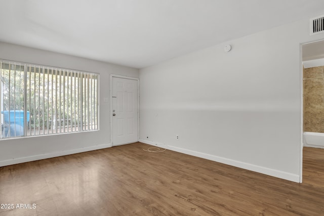 empty room with wood finished floors and baseboards