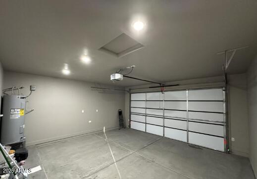 garage with electric water heater and a garage door opener