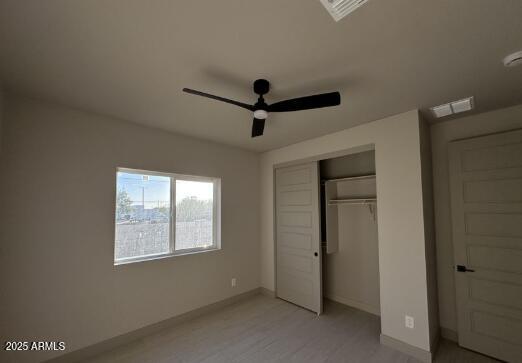 unfurnished bedroom featuring a closet, visible vents, and baseboards