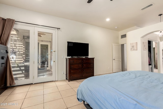 bedroom with visible vents, access to exterior, ceiling fan, arched walkways, and light tile patterned floors