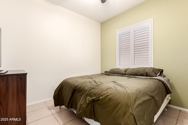 bedroom with baseboards and light tile patterned flooring