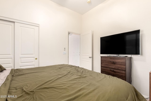 bedroom featuring vaulted ceiling and a closet