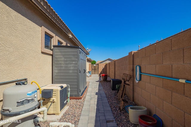 view of side of home featuring a fenced backyard and stucco siding
