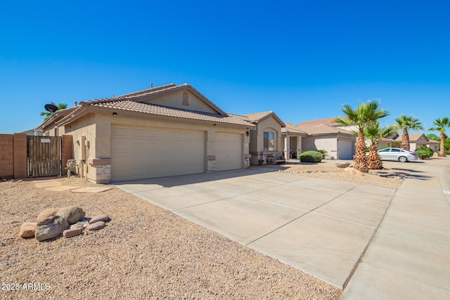 single story home with a garage, stucco siding, a gate, a tiled roof, and driveway