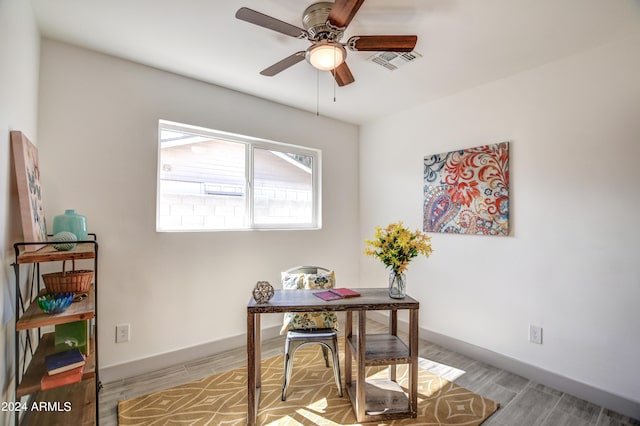 office with light hardwood / wood-style floors and ceiling fan