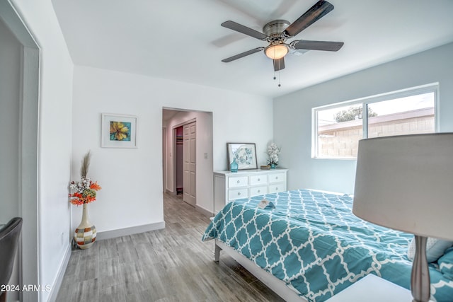 bedroom with light hardwood / wood-style flooring and ceiling fan