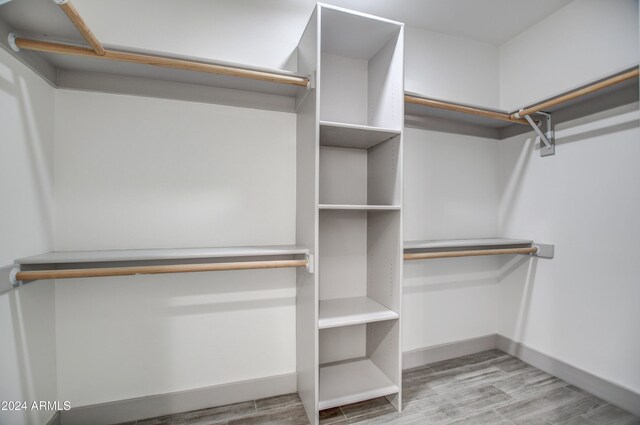 walk in closet featuring light hardwood / wood-style floors