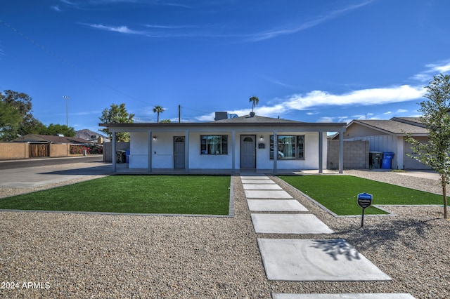 ranch-style home with a front yard and covered porch