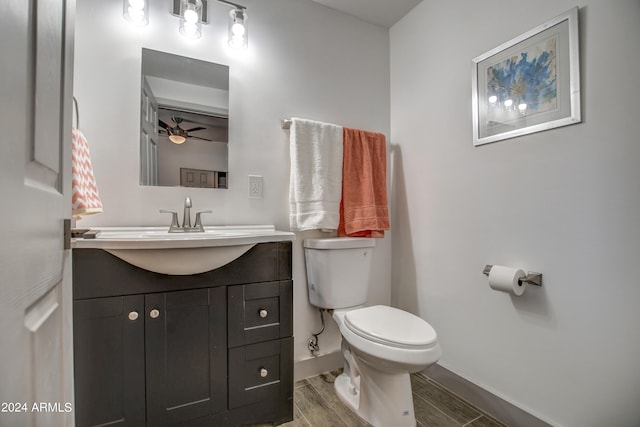 bathroom with vanity, toilet, ceiling fan, and hardwood / wood-style floors