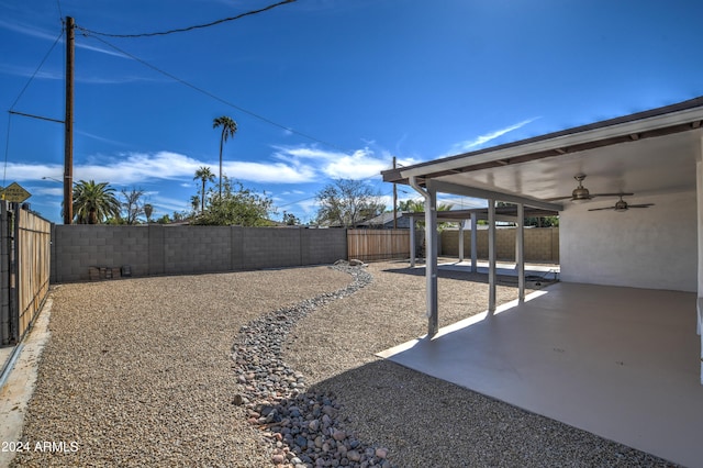 view of yard featuring a patio area and ceiling fan