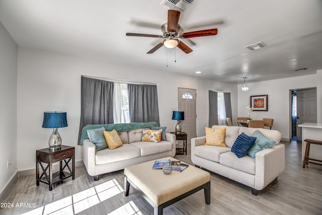 living room with light hardwood / wood-style flooring and ceiling fan