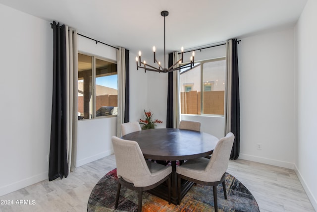 dining room featuring light hardwood / wood-style flooring and an inviting chandelier