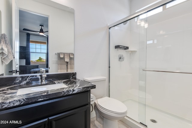 bathroom with walk in shower, vanity, toilet, and ceiling fan