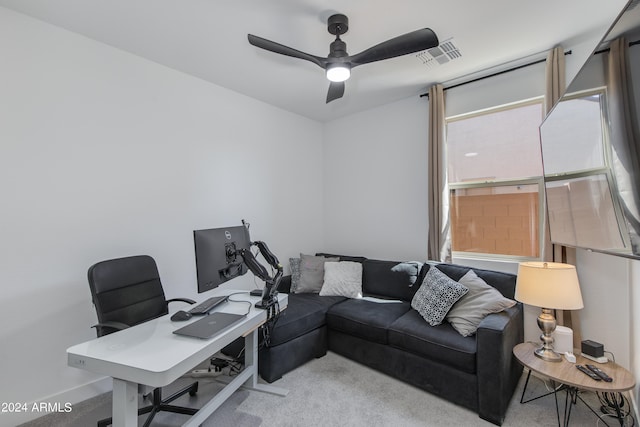 carpeted office featuring ceiling fan