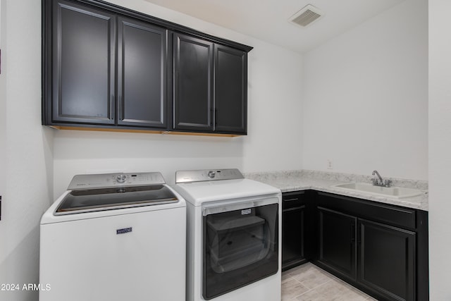 laundry room featuring cabinets, independent washer and dryer, light tile patterned flooring, and sink