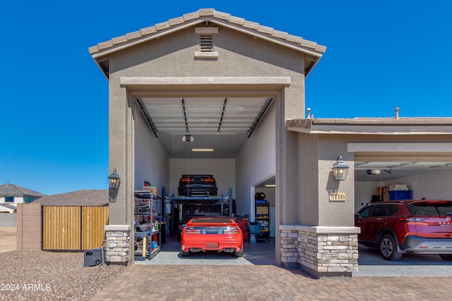 garage with a garage door opener and a carport