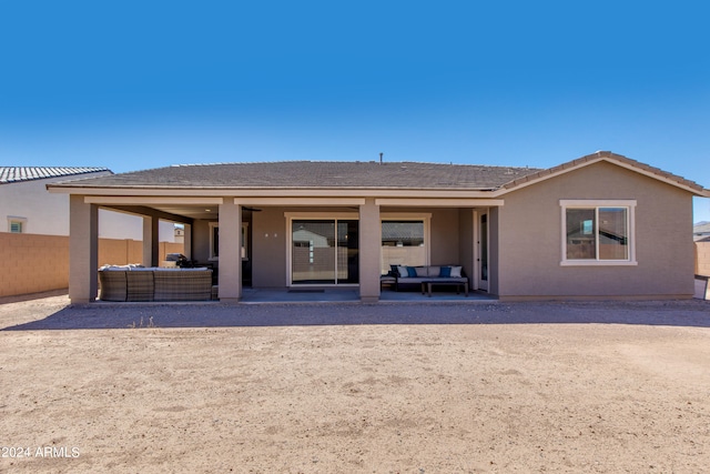 rear view of property featuring outdoor lounge area and a patio area