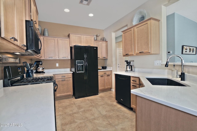 kitchen with visible vents, light brown cabinets, a sink, light stone countertops, and black appliances