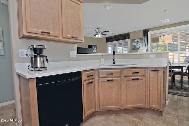 kitchen featuring a peninsula, a sink, a ceiling fan, light countertops, and dishwasher