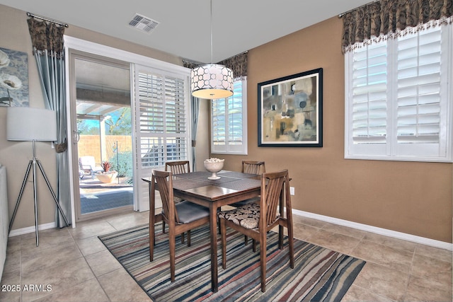 dining area with baseboards, visible vents, a wealth of natural light, and light tile patterned flooring