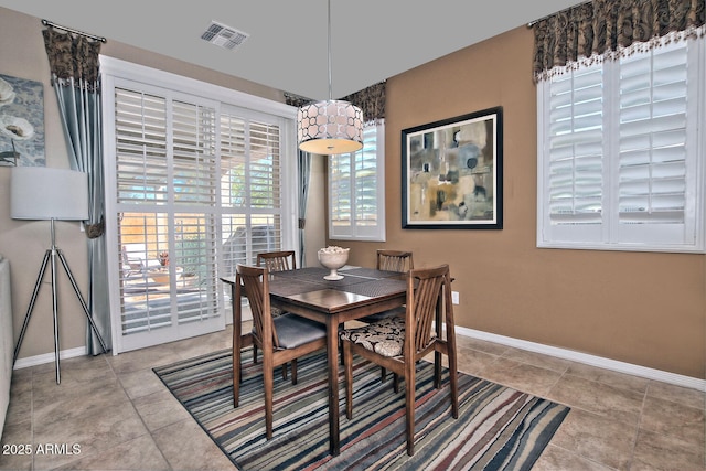 dining area with baseboards, visible vents, and tile patterned floors