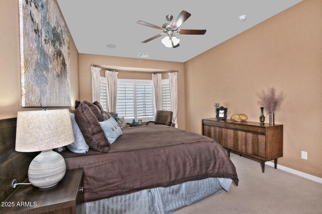 bedroom featuring a ceiling fan, visible vents, baseboards, and carpet flooring