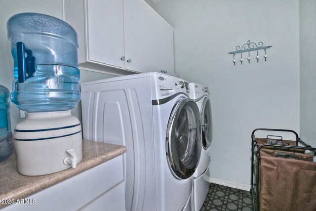 laundry room featuring cabinet space, baseboards, washer and clothes dryer, and tile patterned floors