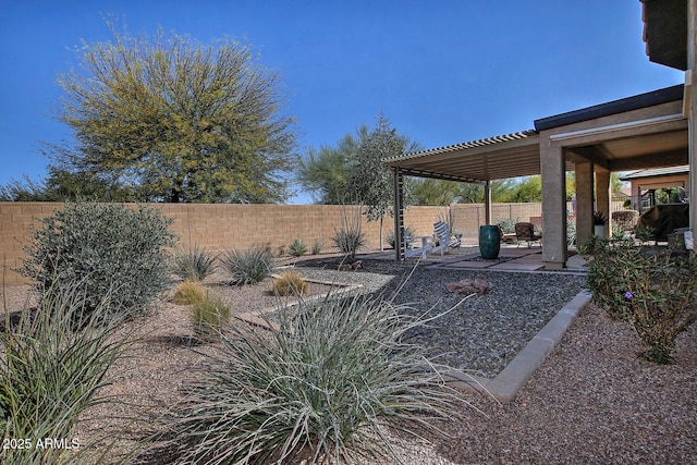 view of yard with a fenced backyard, a patio, and a pergola