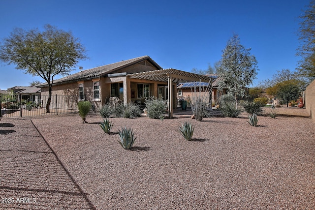 back of property with a patio area, a tile roof, fence, and a pergola