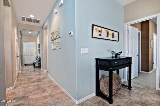 hall with recessed lighting, visible vents, baseboards, and light tile patterned floors