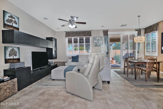 living room featuring a healthy amount of sunlight, ceiling fan, visible vents, and light tile patterned floors