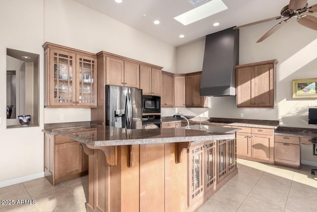 kitchen with wall chimney range hood, a kitchen breakfast bar, a high ceiling, and black appliances