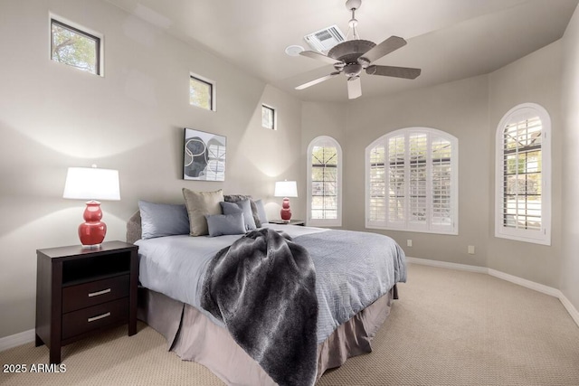 carpeted bedroom featuring multiple windows and ceiling fan