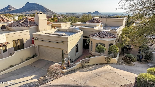 view of front facade featuring a mountain view and a garage