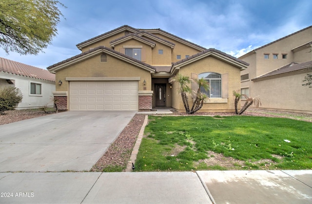 view of front of home featuring a front yard and a garage