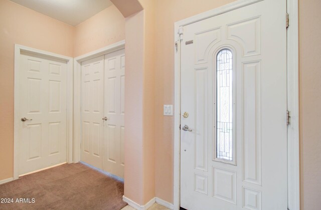 5659 S 239th Dr, Buckeye, AZ 85326 - foyer entrance with arched walkways, light colored carpet, and baseboards