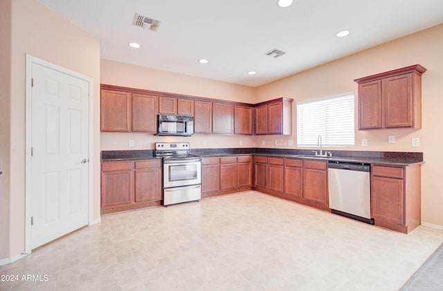5659 S 239th Dr, Buckeye, AZ 85326 - kitchen featuring stainless steel appliances, visible vents, a sink, and dark countertops