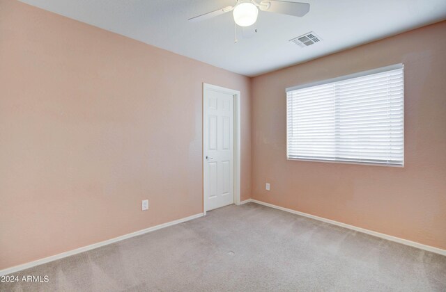5659 S 239th Dr, Buckeye, AZ 85326 - empty room featuring visible vents, ceiling fan, baseboards, and carpet floors