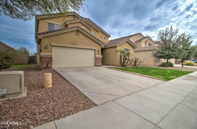 view of front of house featuring a front lawn and a garage