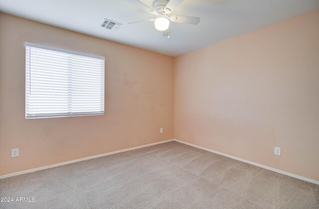 5659 S 239th Dr, Buckeye, AZ 85326 - empty room with visible vents, baseboards, a ceiling fan, and light carpet