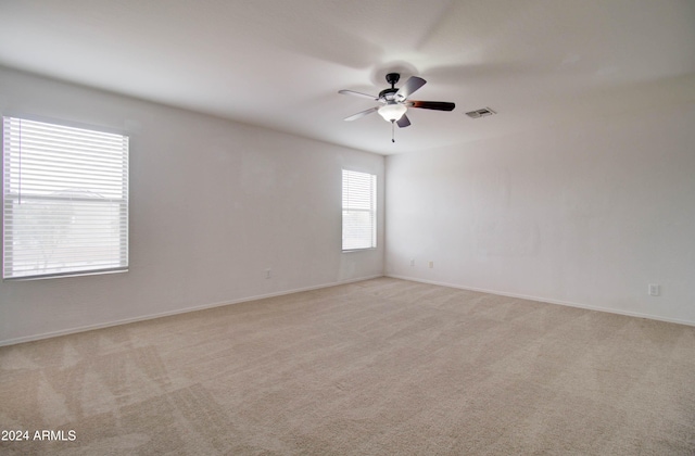 5659 S 239th Dr, Buckeye, AZ 85326 - unfurnished room with light carpet, visible vents, baseboards, and a ceiling fan