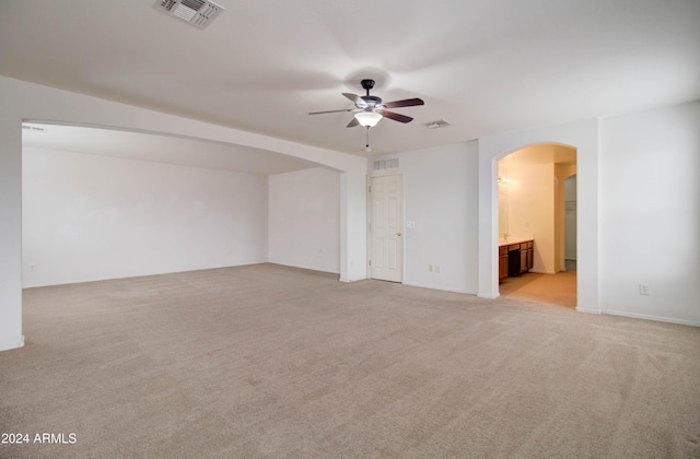 5659 S 239th Dr, Buckeye, AZ 85326 - interior space featuring visible vents, a ceiling fan, arched walkways, and light carpet